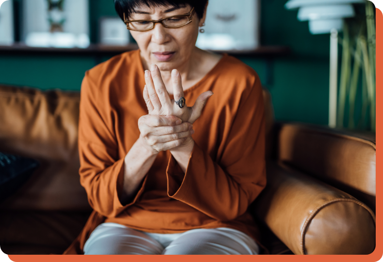 patient thinking about arthritis treatment options while touching her own hand