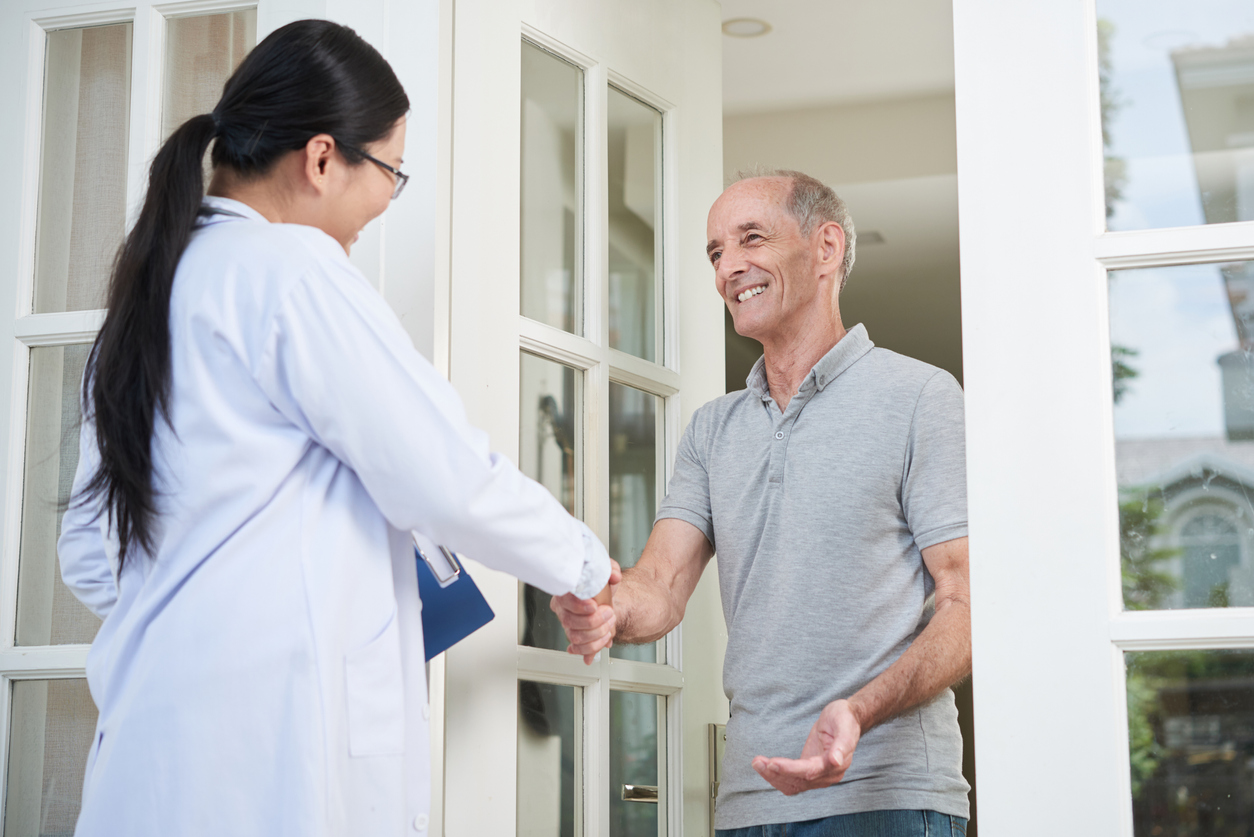 patient shakes a providers hand at the beginning of an at-home doctor visit