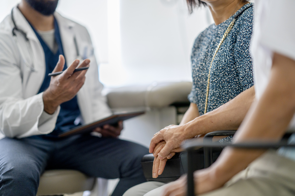 doctor discussing the difference between palliative care and hospice to two clients